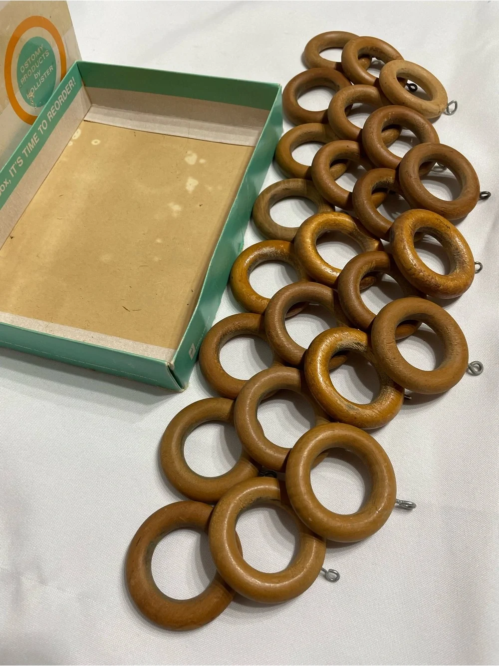 Set of 24 vintage wooden curtain rings feature metal screw eyes for drapery